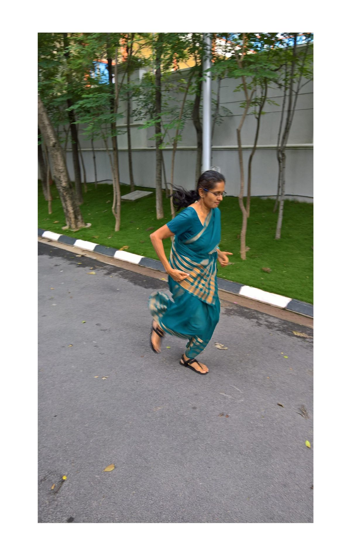 Jayanthi running in a sari on the road