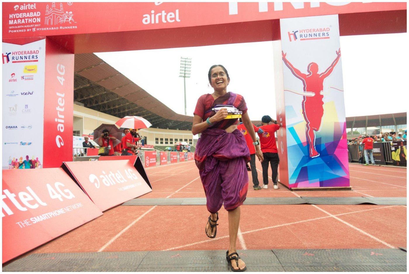 Jayanthi crossing the finish line at the Airtel Hyderabad Marathon in a sari
